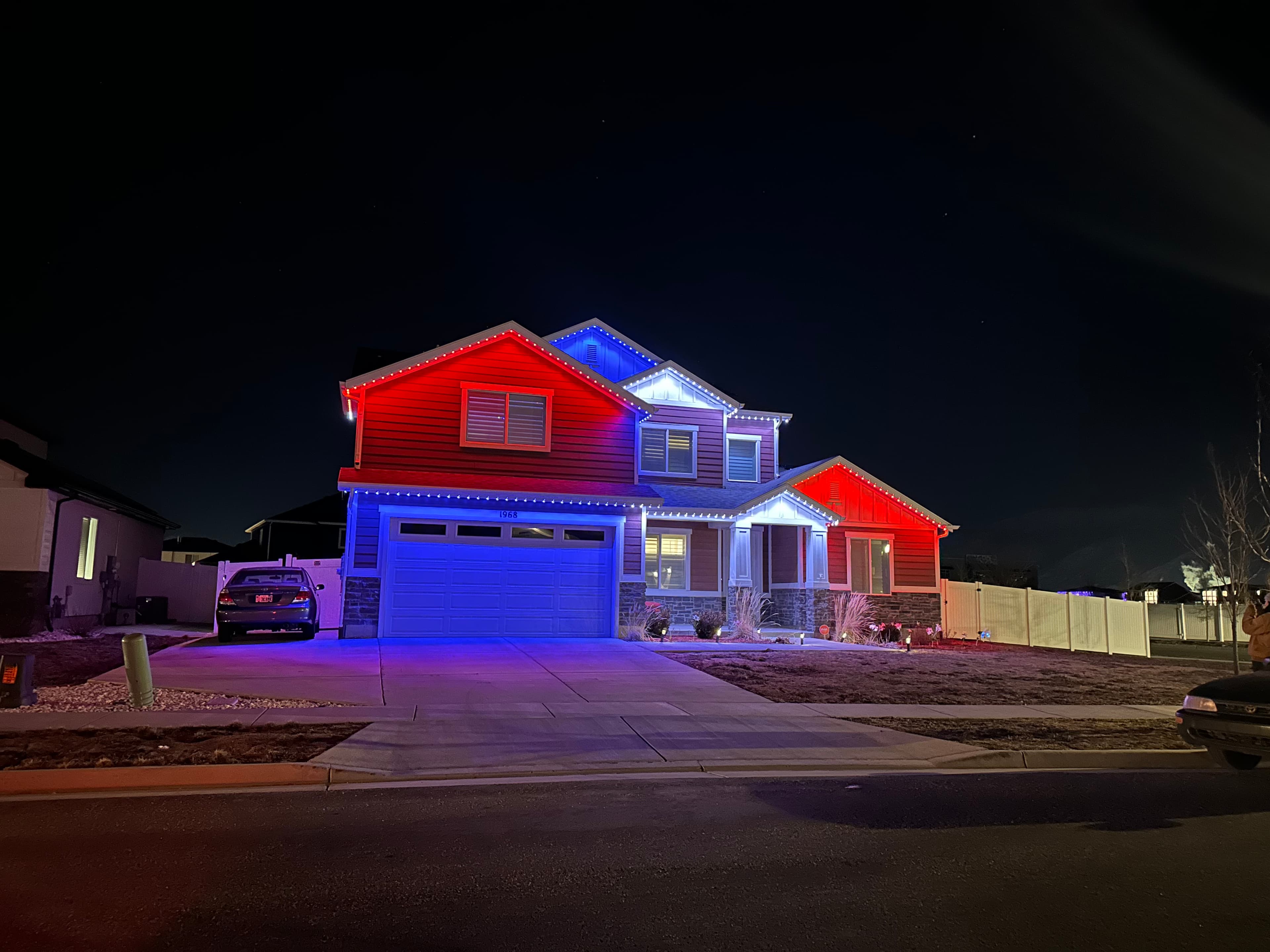 A roofline lit in red, white and blue for game day